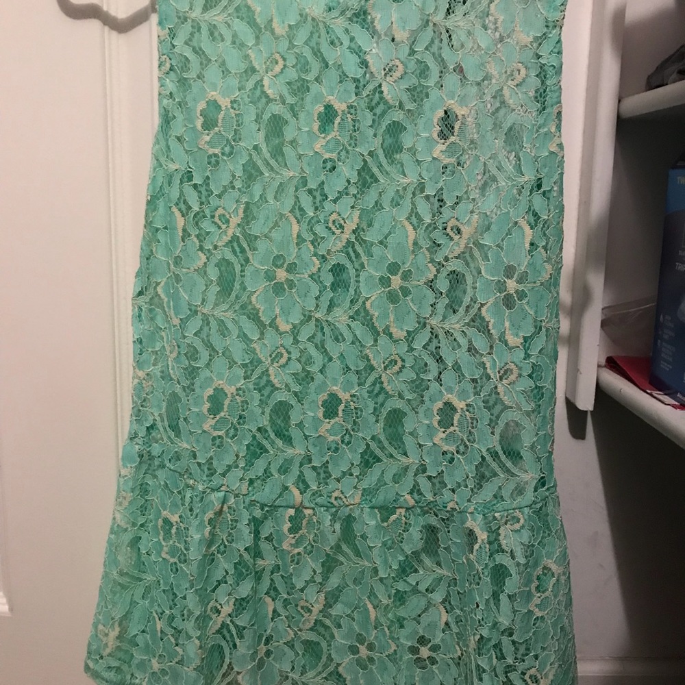 Mint green peplum tank with gold bottom closure